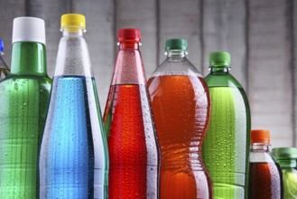 Plastic bottles of assorted carbonated soft drinks in variety of colors
