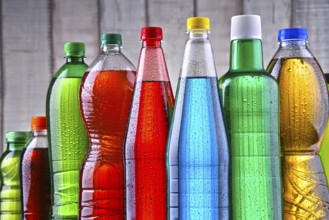 Plastic bottles of assorted carbonated soft drinks in variety of colors