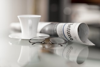 Still life with daily newspaper, glasses and coffee cup