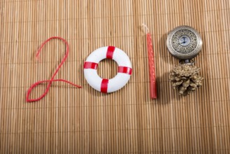 Happy Year 2018 decoration with life preserver, coins, cone and watch