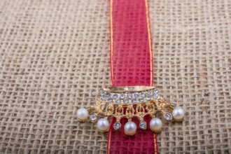 Model crown placed on a band on linen canvas