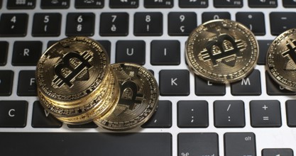 Bitcoins on Computer Keyboard Background