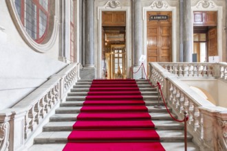 Turin, Italy - Circa January 2022: red carpet in Royal Palace - luxury elegant marble stairway