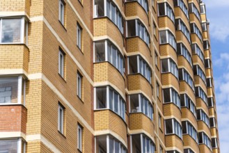 Modern high-rise apartment building made of a brick