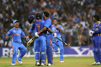 Mahendra Singh Dhoni 2R team mate Yuvraj Singh R Piyush Chawla R Ashwin L celebrate ICC Cricket