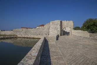 Skyline of a small Mediterranean town, historic city centre with massive city walls on an island in