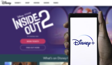 Smartphone with Disney+ logo displayed on the screen.