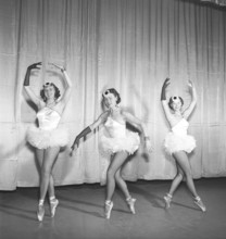 Ballerinas in the 1950s. Three young ballerinas all dressed up in their costume and shoes posing on