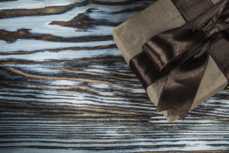 Packed brown gift box on wooden background