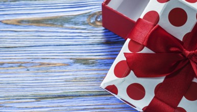 Present box on vintage wooden background