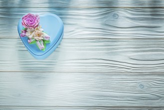 Present box on wooden board top view holidays concept