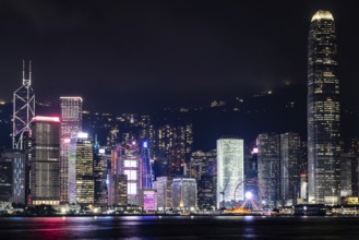 HONG KONG, CHINA - SEPTEMBER 27 2024: Night time view of Hong Kong Island and Victoria Harbour from