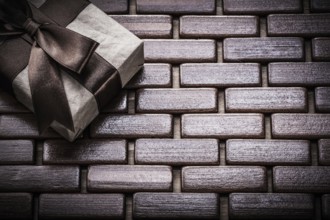 Packed giftbox on wooden wicker matting holidays concept