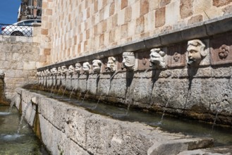 Famous mediaeval Fountain of 99 Spouts in ithe old town of L'Aquila, Abruzzi in Italy