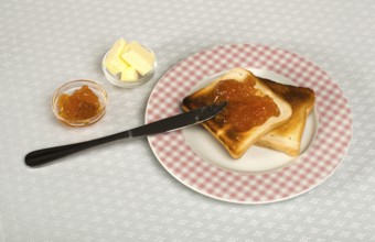 Spread jam on bread with knife