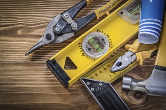 Blue blueprints construction level square ruler claw hammer pliers steel cutter on wooden board