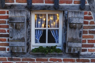 Rustic window with blue curtains and Christmas lights, weseke, borken, münsterland, North