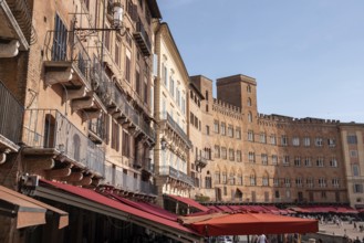 Old medieval brick houses surrounding the famous Piazza del Campo in the center of Siena, Italy,