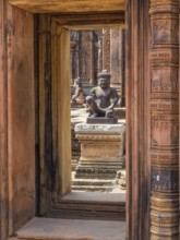 Kneeling guardians keep watch over the interior of the 'Citadel of the women', Banteay Srei,