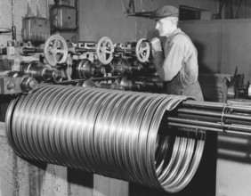 Factory in the 1950s. A worker at the bicycle and motorcycle company Monark in Sweden. The machine