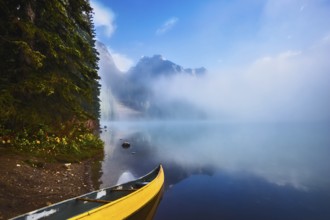 Fishing boats moored on the shore. Foggy morning on Emerald Lake. Canada, Yoho National Park