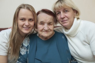 Family portrait of three generations. Mother, daughter and grandmother smiling