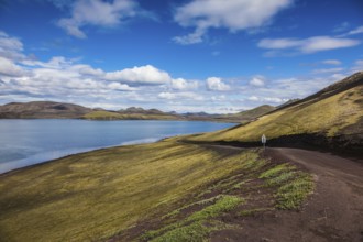 Summer travel to Iceland. Rhyolitic mountains surround the volcanic lake with cold water