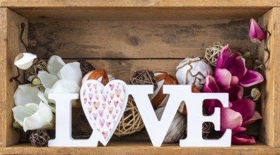 An image of a love decoration in a wooden box