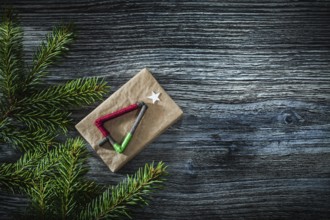 Pine tree branches gift box on wooden board