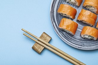 Rolls Philadelphia With Salmon Eel On Blue Background