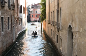 Man on a boat in Venice. Pass thru the channel