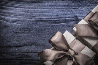 Wrapped gift boxes on wooden board holidays concept