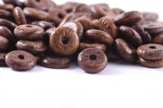 Wooden beads close-up on white background. Close up, macro
