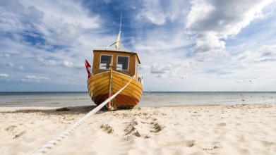 Small fishing boat on the Baltic Sea beach on the island of Usedom, on a beautiful sunny day