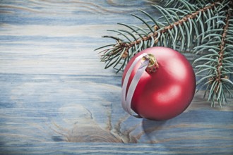 Pine branch red shining bauble on wooden board celebrations concept