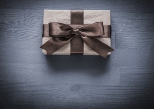 Present box on vintage wooden board holiday concept