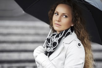 Beautiful woman with umbrella in the rain