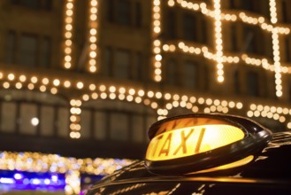 Taxi in London in front of a shopping center in the night