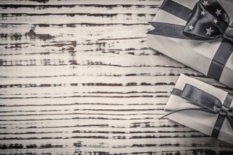 Wrapped gift containers on vintage wooden board copyspace holidays concept