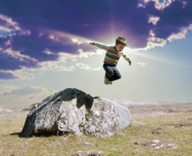 Jumping boy from big rock