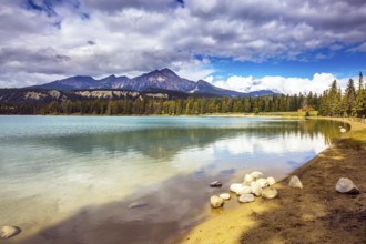 Pretty round lake in the coniferous forest. Canadian Rocky Mountains, Jasper National Park, lake
