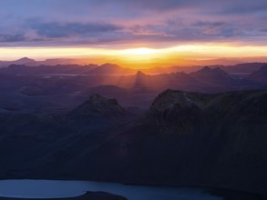 Cloudy mood and evening light at sunset, view from Mount Sveinstindur, volcanic landscape, Lake