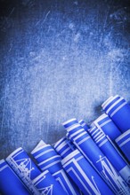 Blue blueprints on scratched metallic background construction concept