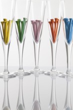 Glasses of champagne and golf equipments on a glass table