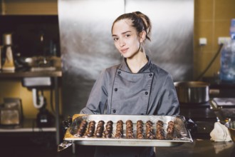 Subject profession and cooking pastry. young Caucasian woman with tattoo of pastry chef in kitchen