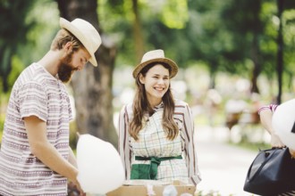 Theme is a family small business cooking sweets. A pair of lovers A young man and woman trader in