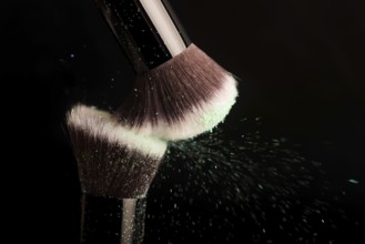Cosmetics brush and colorful makeup powder