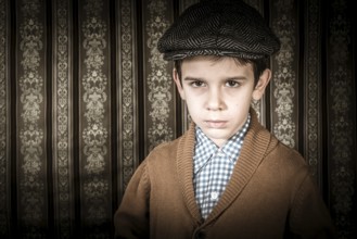 Frowning child in vintage clothes and hat. Close up shot
