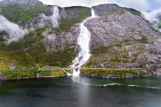 Langfossen cascade waterfall on the Vaule river. Western Norway. Passes through the highway. The