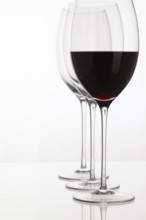 Wineglass with red wine on a white background